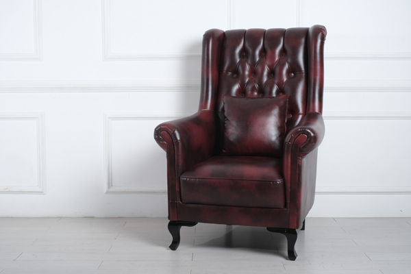 chesterfield armchair against white accent wall